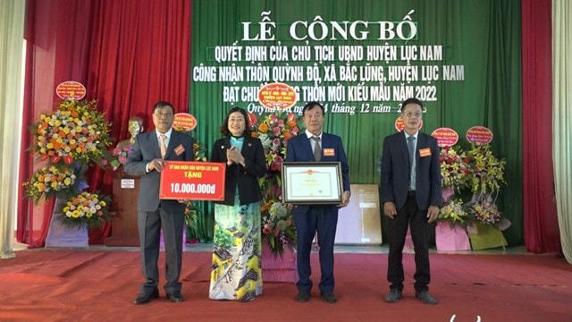 Bà Giáp Thị Hải - Trưởng ban Dân vận, Chủ tịch Ủy ban MTTQ huyện Lục Nam trao chứng nhận và tiền thưởng cho cán bộ và nhân dân thôn Quỳnh Độ, xã Bắc Lũng đạt chuẩn nông thôn mới kiểu mẫu.