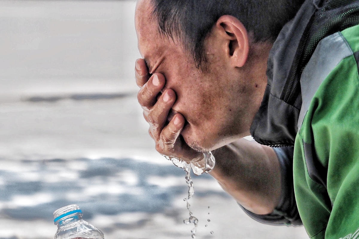 Tài xế công nghệ phải dùng nước để làm mát cho cơ thể sau chuyến xe.