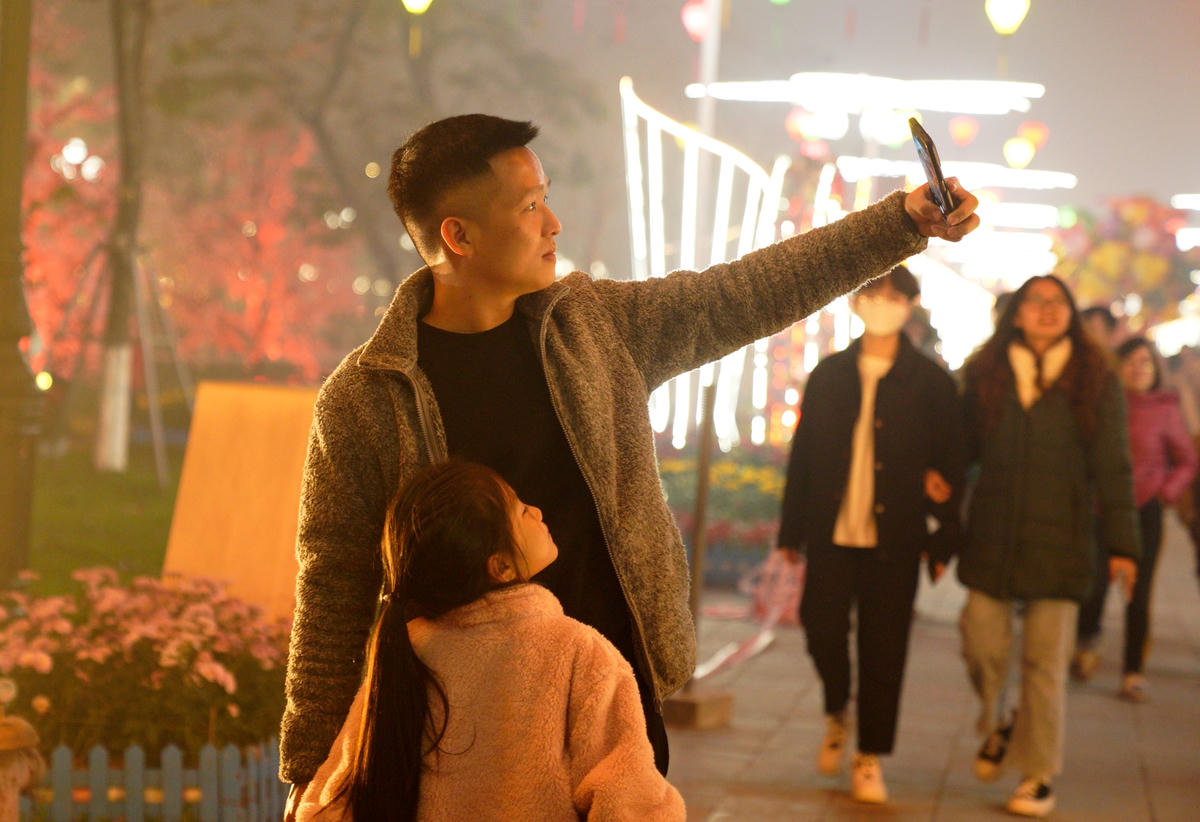 Ba và con cùng nhau ghi lại khoảnh khắc thiêng liêng chào đón năm mới.