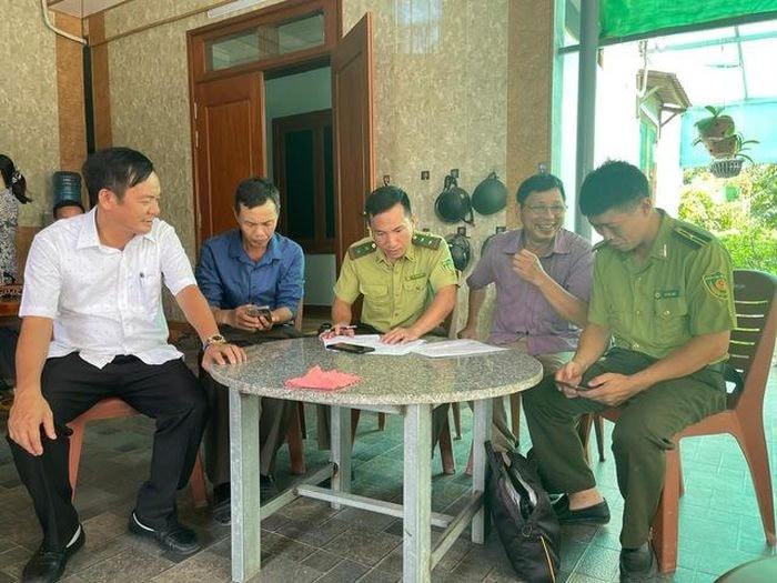 Chính quyền địa phương cùng người dân làm thủ tục bàn giao cá thể kỳ đà cho Vườn Quốc gia Vũ Quang.