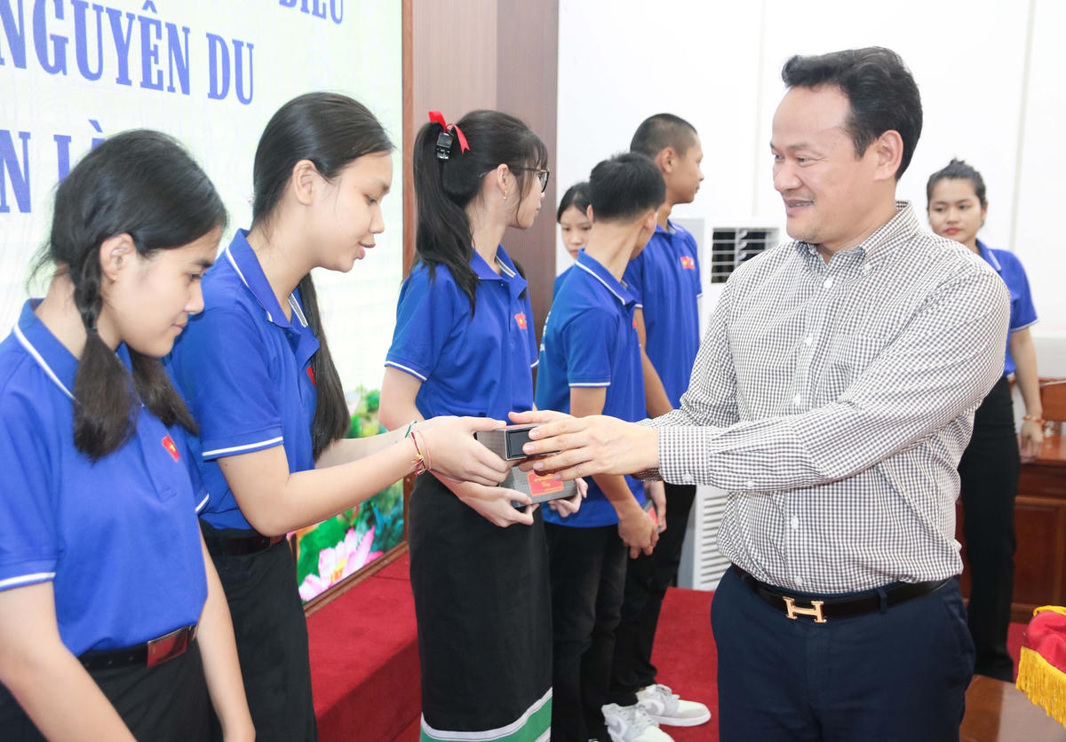 Ông Mai Phan Dũng, Phó Chủ nhiệm Ủy ban Người Việt Nam ở nước ngoài tặng quà lưu niệm cho các em học sinh tại buổi gặp mặt.