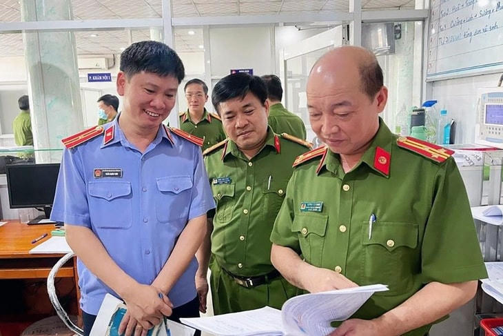 Lực lượng chức năng kiểm tra các tài liệu, chứng cứ liên quan vụ án. Ảnh: Công an cung cấp.