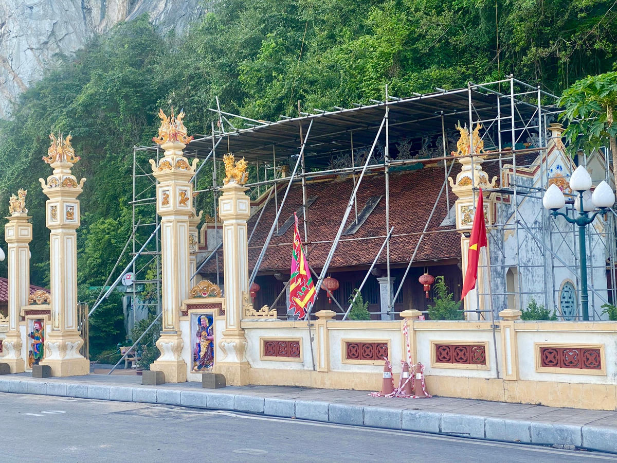 Đơn vị thi công đã lắp đặt giàn giáo, dùng ván phủ phim bao che toàn bộ phía trên mái che bài thơ cổ.