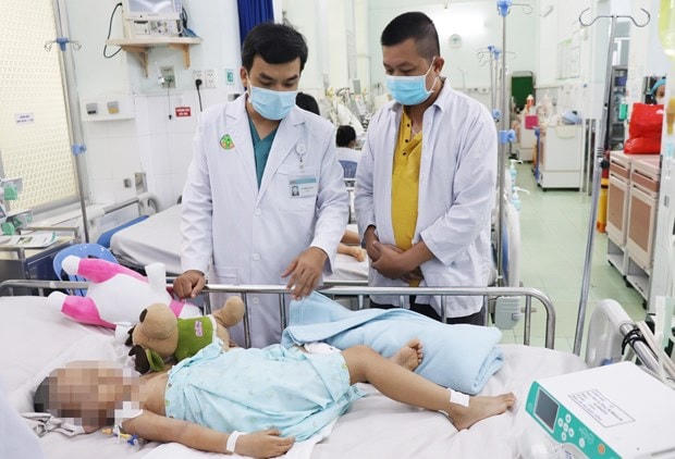 Bác sĩ Bệnh viện Nhi đồng 2 TPHCM điều trị cho trẻ mắc bệnh tay chân miệng. Ảnh: TTXVN.