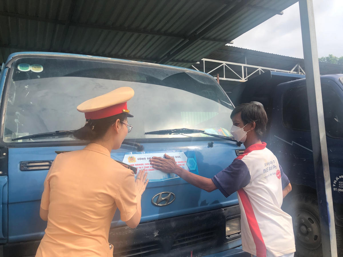 CSGT TP Thủ Đức tổ chức dán băng rôn tuyên truyền tại một nhà xe tại phường Linh Đông, TP Thủ Đức sáng nay 15/7. (Ảnh: Hồng Phúc). 