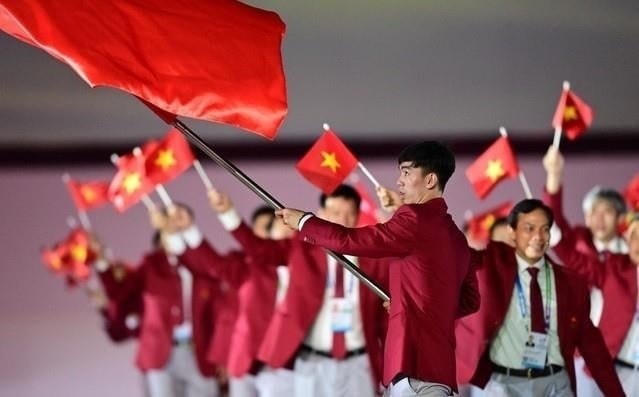 Kình ngư Nguyễn Huy Hoàng cầm cờ cho đoàn thể thao Việt Nam tại khai mạc SEA Games 32.