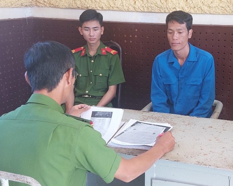 Đối tượng Vũ Văn Hạnh (mặc áo xanh) tại cơ quan điều tra.