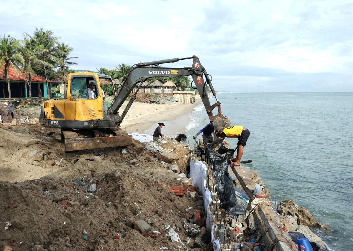 Người dân TP Hội An huy động máy móc gia cố lại bờ kè biển chống sạt lở.