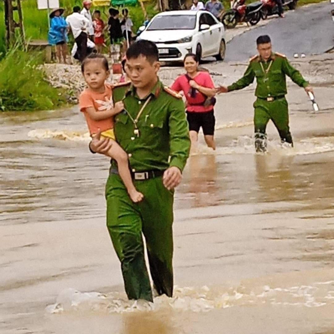 Công an xã Tân Phúc (huyện Lang Chánh) hỗ trợ người dân đi qua khu vực các đường tràn.