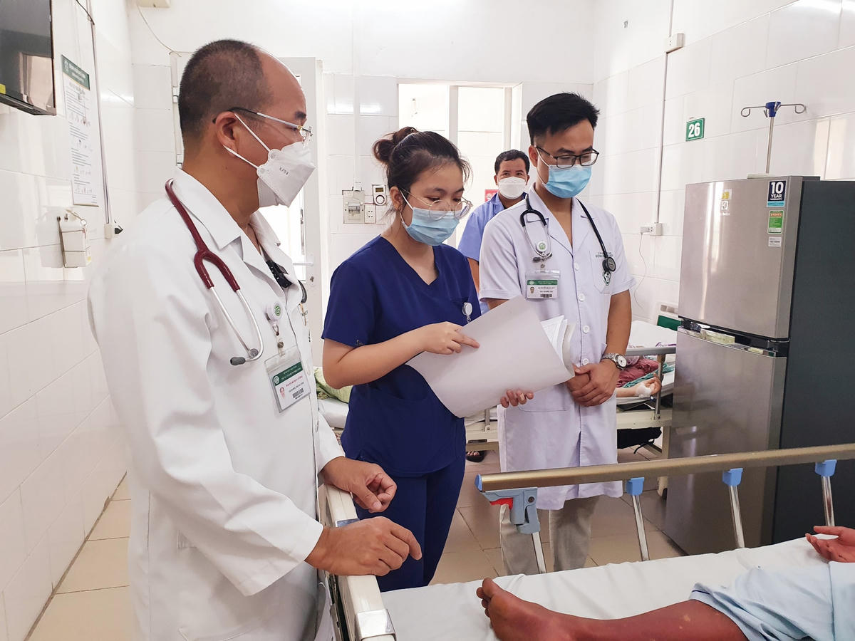 Các bác sĩ Bệnh viện Bạch Mai thăm khám cho bệnh nhân sốt xuất huyết đang điều trị.