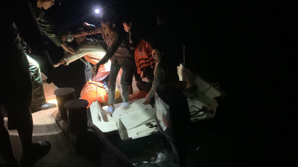 4 ngư dân được lực lượng chức năng cứu sống và đưa vào bờ an toàn. Ảnh: QMG