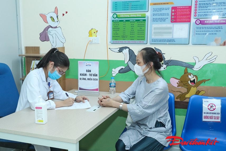 Tư vấn cho người dân trước tiêm chủng. Ảnh: Quang Vinh.