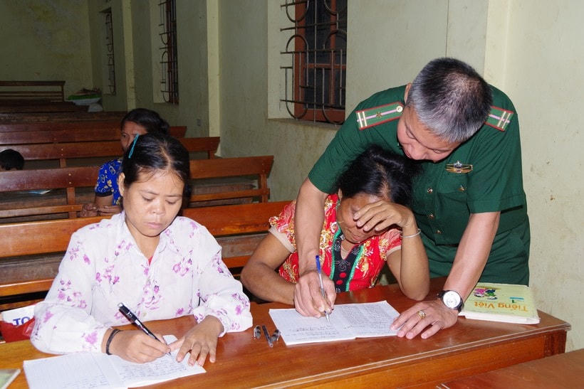 Cán bộ Biên phòng tận tình hướng dẫn các học viên viết chữ. (Ảnh: Hải Thượng).