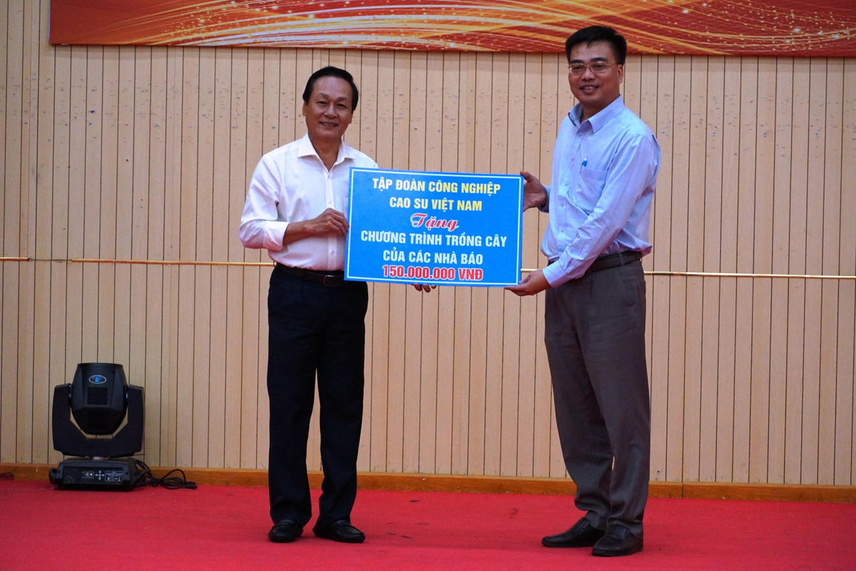 Tập đoàn công nghiệp cao su Việt Nam trao bảng tượng trưng cho lãnh đạo tỉnh Bình Phước chương trình trồng cây xanh. Ảnh: Mạnh Thìn. 