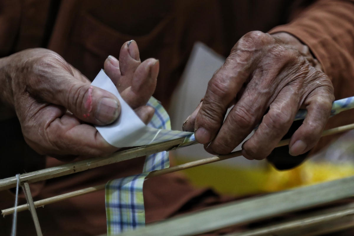 Sau đó ông dùng giấy để bọc xung quanh các khung tre để tạo độ thẩm mỹ cho đèn.