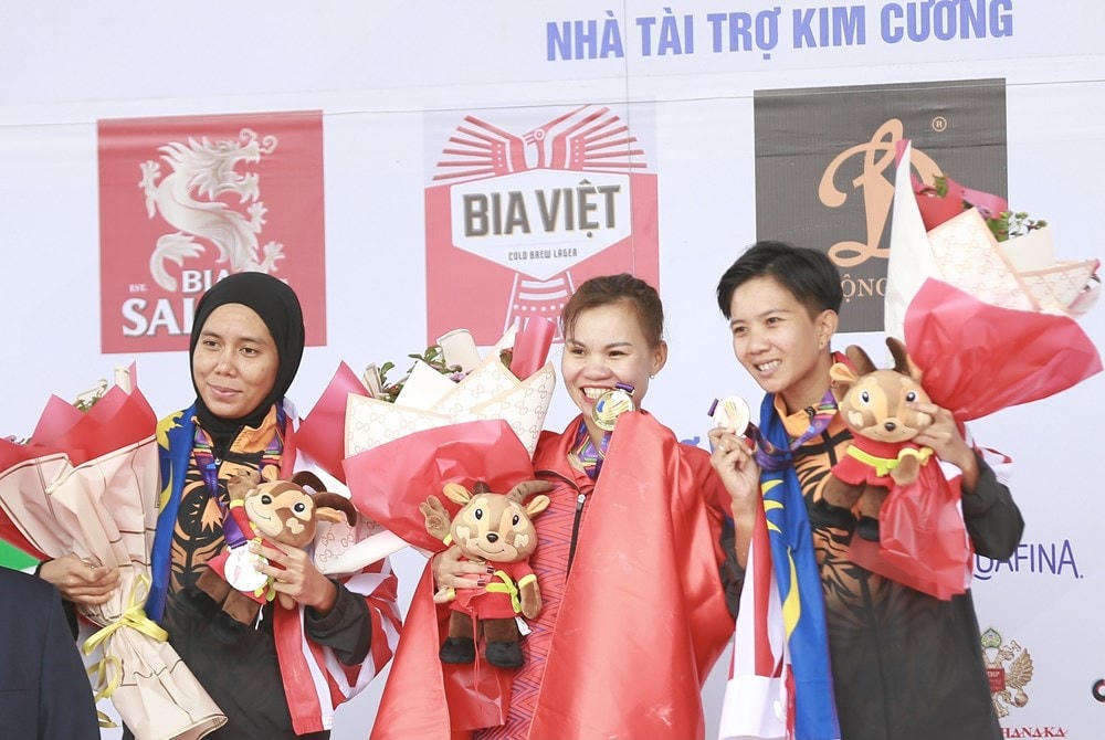 Trao Huy chương cho các VĐV, HCV thuộc về VĐV Việt Nam Đinh Thị Như Quỳnh, HCB và HCĐ thuộc về hai VĐV Malaysia lần lượt là Zainal Abindin Nuasyira (ngoài cùng bên trái) và Soon Natahsya. (Ảnh: Trọng Đạt/TTXVN).