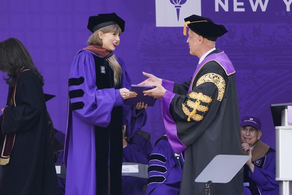 Taylor Swift nhận bằng danh dự từ Chủ tịch Đại học New York Andrew Hamilton trong buổi Lễ tốt nghiệp của Đại học New York.
