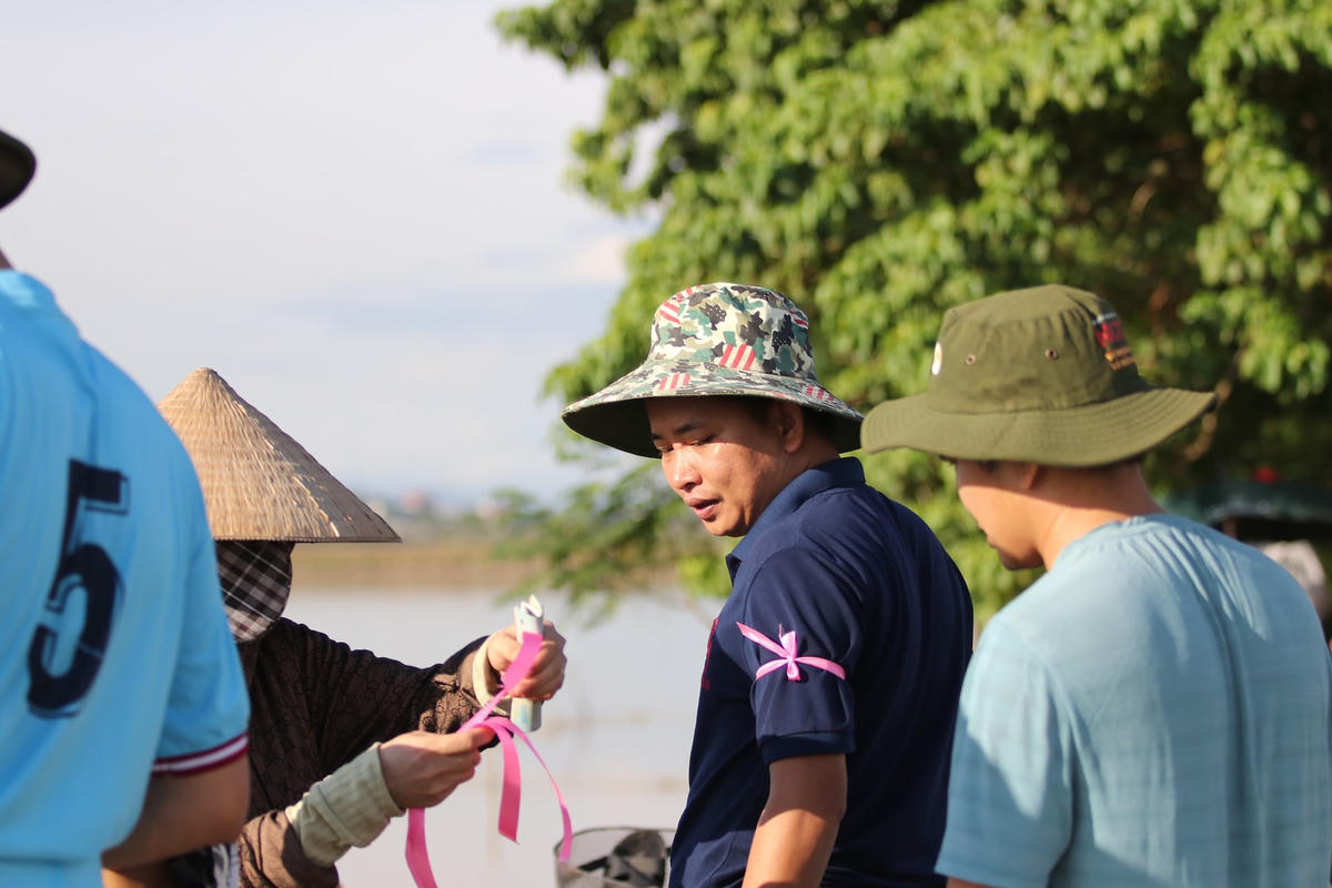 Người dân khi muốn xuống hồ thủy lợi để "săn cá", phải mua vé với giá 100.000 đồng/vé sau đó chủ hồ sẽ dùng dây vải màu hồng buộc vào cánh tay "nơm thủ" để đánh dấu.