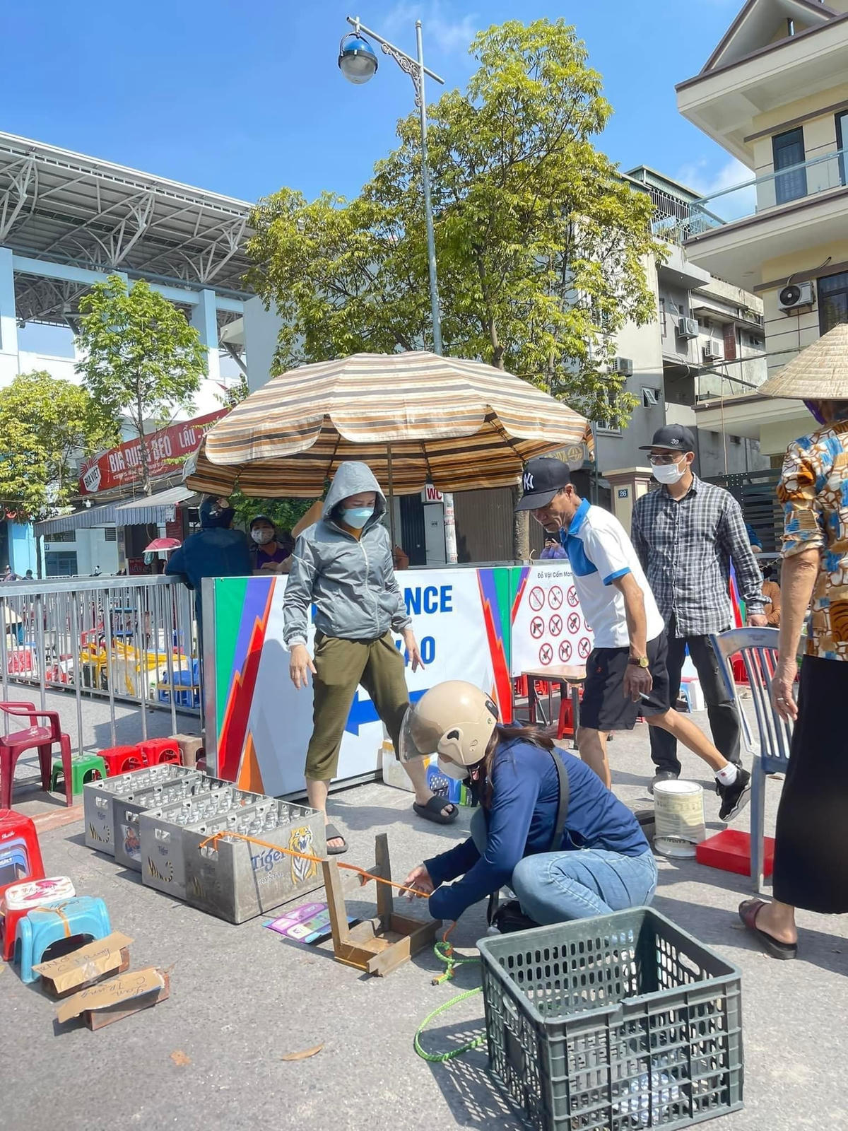 Người dân dùng ghế nhựa, giày dép, thùng bia... và nhiều loại vật dụng khác để "xếp lốt" từ sáng sớm. Ảnh: Facebook.