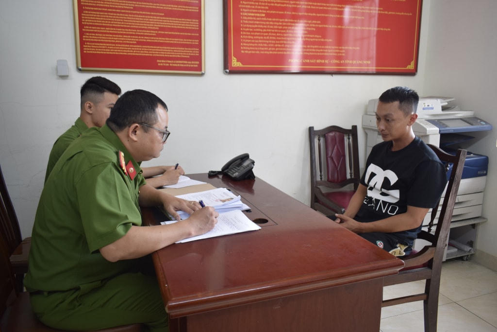Cán bộ điều tra lấy lời khai đối tượng Nguyễn Quang Kiên. Ảnh: Báo Quảng Ninh
