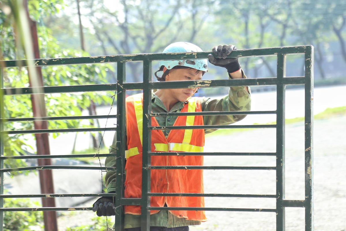 Các công nhân tiến hành vận chuyển sắt thép lên xe sau khi công trình được phá dỡ.