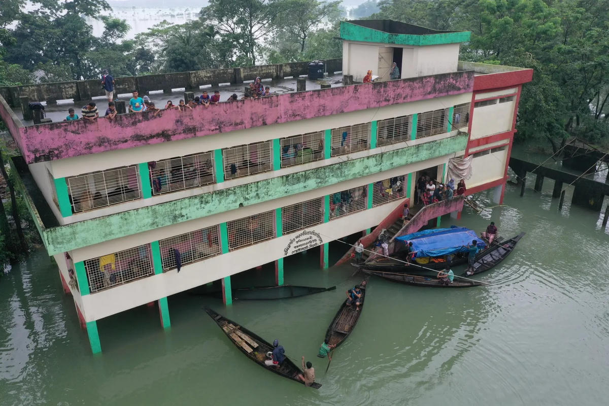 Mọi người trú ẩn tại một trường học trong trận lũ lụt ở Gowainghat.
