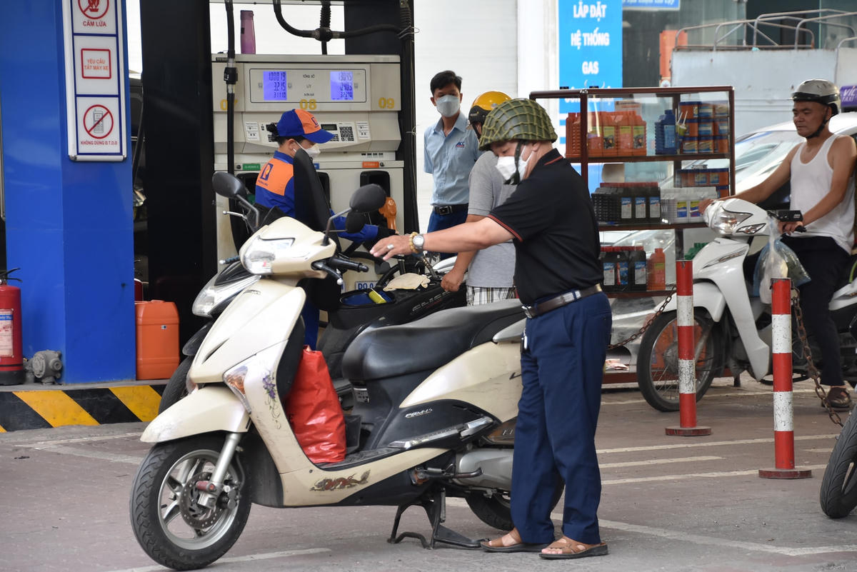 Nhiều người dân cũng tranh thủ đổ xăng cho xe máy trước giờ đi làm.