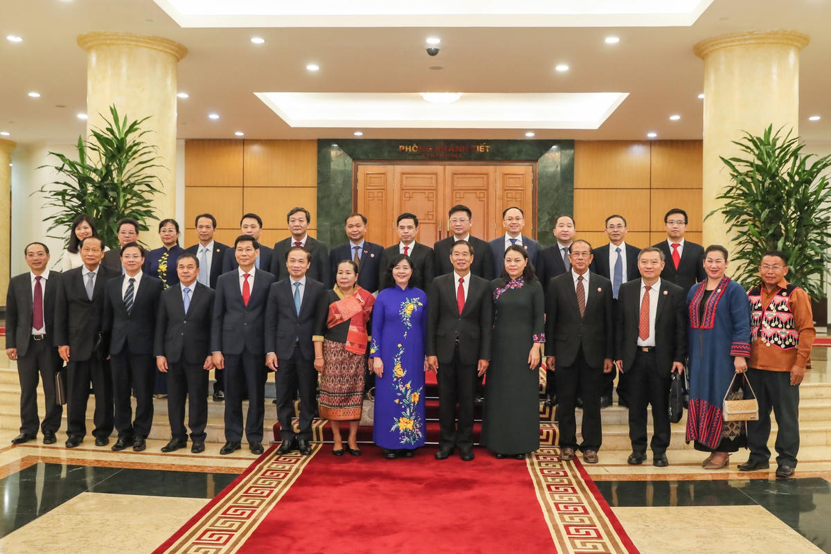 Trưởng Ban Dân vận Trung ương Bùi Thị Minh Hoài và Chủ tịch Ủy ban Trung ương Mặt trận Lào xây dựng đất nước Sinlavong Khoutphaythoune cùng các đại biểu chụp ảnh lưu niệm. Ảnh: Quang Vinh.