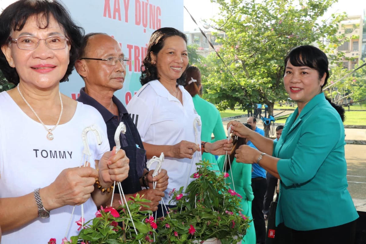 Chủ tịch Ủy ban MTTQ Việt Nam Thành phố Trần Kim Yến tặng chậu cây cảnh cho người dân tại chương trình.