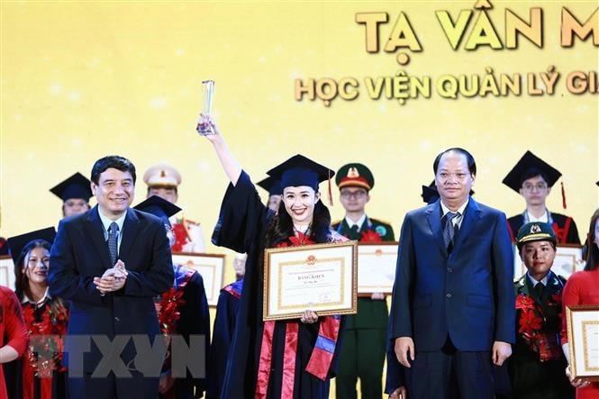 Chủ nhiệm Ủy ban Văn hóa, Giáo dục của Quốc hội Nguyễn Đắc Vinh trao tặng bằng khen cho các thủ khoa. (Ảnh: Minh Đức/TTXVN).