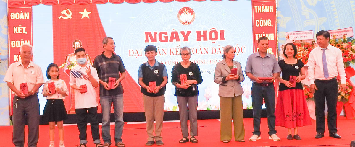 Phó Bí thư Thường trực Thành ủy, Chủ tịch HĐND TP Đà Nẵng Lương Nguyễn Minh Triết (phải) trao quà cho cáchộ dân còn khó khăn. Ảnh: Thanh Tùng.