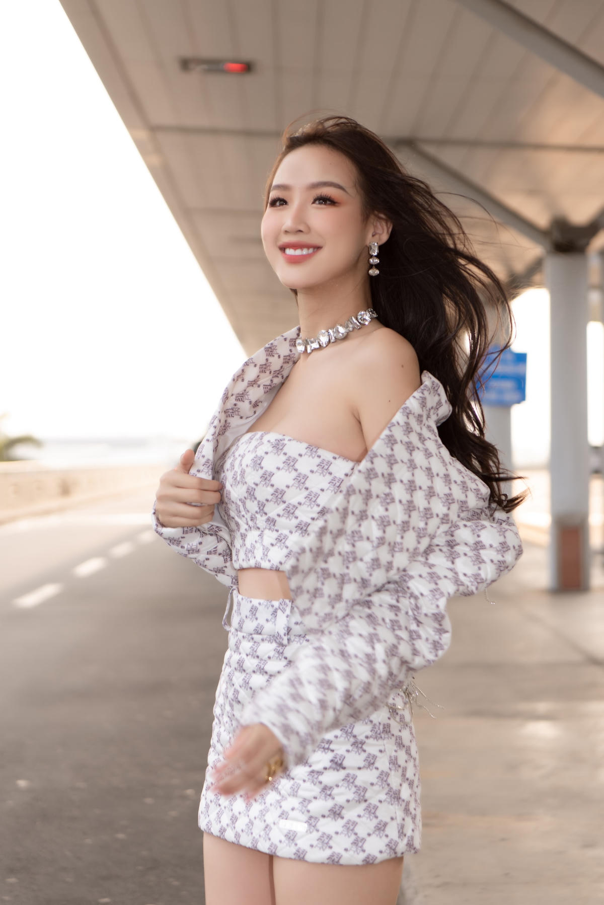 Trong hình, Hoa hậu Bảo Ngọc diện set trắng ca-rô của thương hiệu Việt Nam. Hoa hậu Liên lục địa 2022 diện chiếc váy ngắn cùng với chiếc croptop và chiếc áo khoác hở eo cùng hoạ tiết.