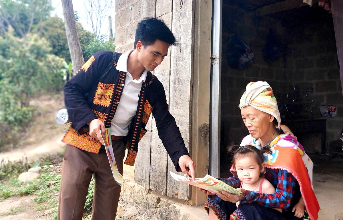 Phát tờ rơi tuyên truyền cho đồng bào dân tộc Dao tại xã Vân Sơn (huyện Sơn Động, tỉnh Bắc Giang). Ảnh: Xuân Thỏa.