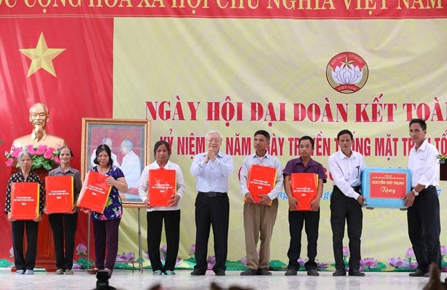 Tổng Bí thư Nguyễn Phú Trọng tặng quà cho bà con tham dự Ngày hội đại đoàn kết toàn dân tộc tại Làng văn hóa Thượng Điện, xã Vinh Quang, huyện Vĩnh Bảo, TP Hải Phòng, ngày 15/11/2017. Ảnh Quang Vinh.