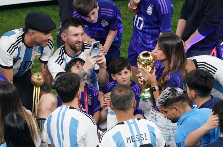 Messi cầm điện thoại chụp ảnh cho vợ.