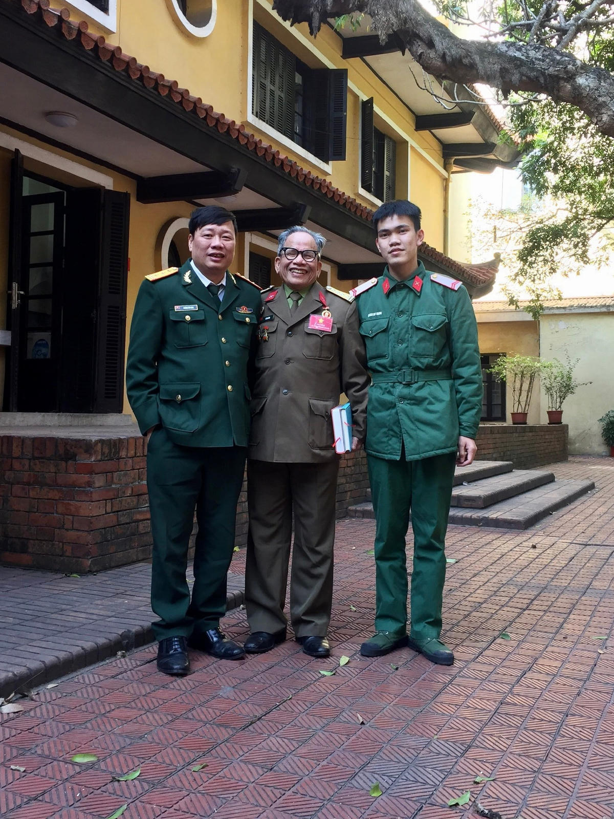 Họa sĩ Lê Duy Ứng (người đứng giữa) trước Nhà số 4 Lý Nam Đế.  