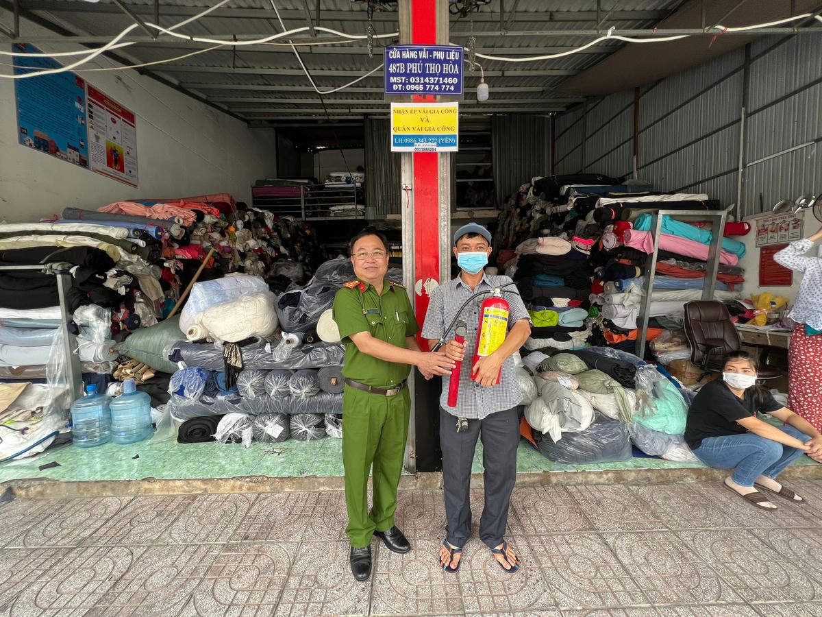 Đại tá Lại Phước Xuân – Uỷ viên thường vụ Quận uỷ, Bí thư Đảng ủy, Trưởng CA Quận tặng thiết bị PCCC cho người dân.