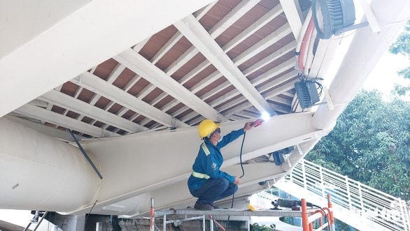 Trước đó, các công nhân đã vá một số vị trí dưới gầm cầu Nguyễn Thái Học. Ảnh: Bửu Đầu.