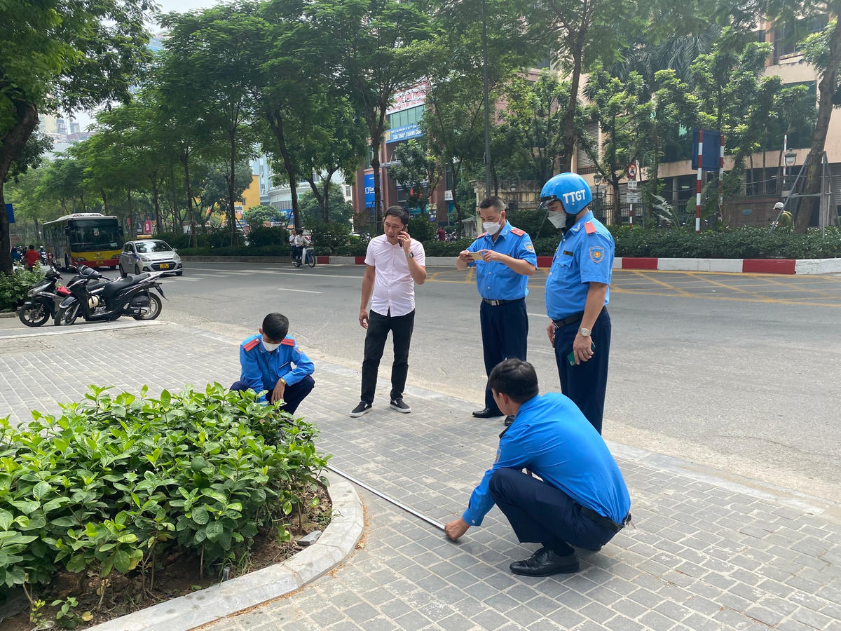 Đội Thanh tra giao thông vận tải quận Ba Đình đo đạc lập biên bản hiện trạng bồn hoa.