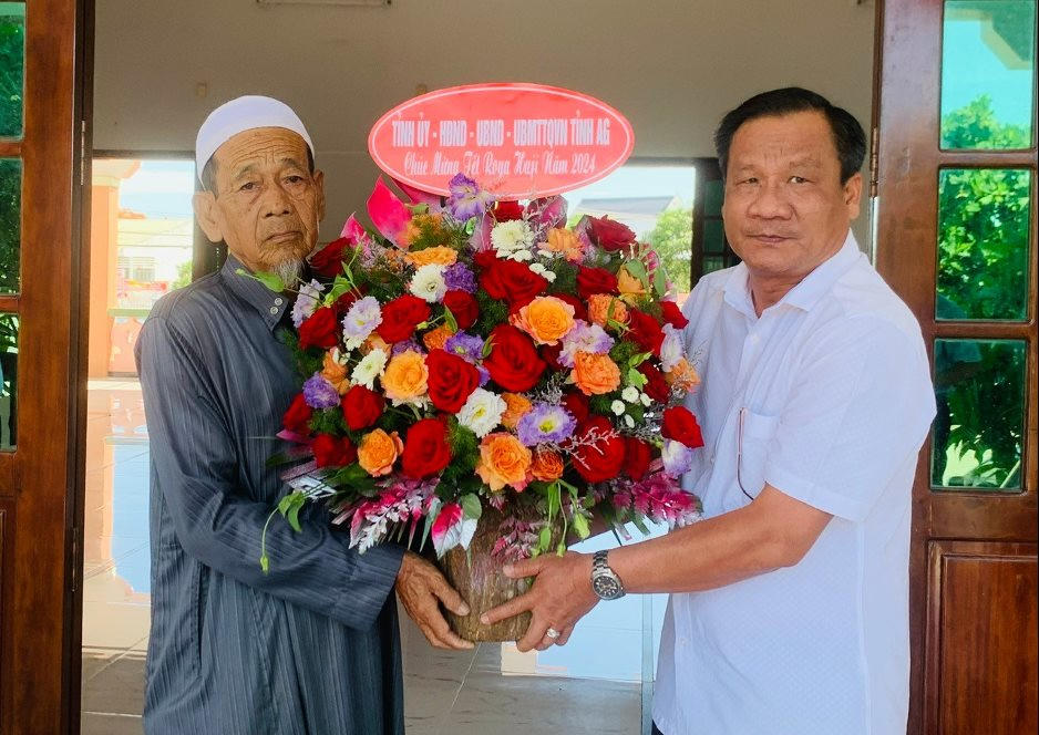 Ông Trương Hoàng Trọng - Phó Chủ tịch Uỷ ban MTTQ Việt Nam tỉnh An Giang tặng hoa cho Phó giáo cả thánh đường xã Quốc Thái - huyện An Phú.
