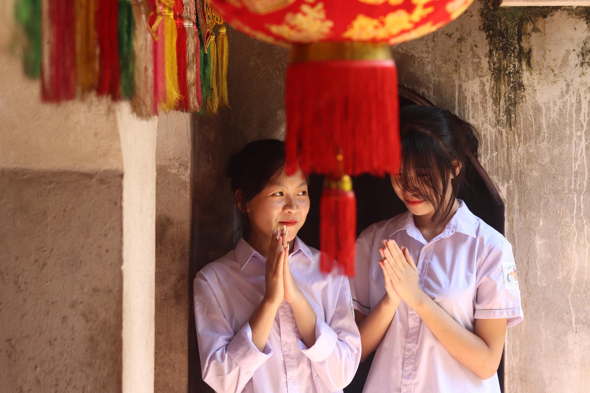 Bên trong đền, các bạn trẻ và người dân chắp tay cầu khấn những điều tốt đẹp cho bản thân và gia đình. Ảnh: Đình Minh 