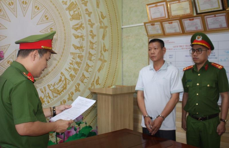 Đối tượng Nguyễn Phước Hùng nghe công an đọc lệnh bắt giam. Ảnh: Công an Đà Nẵng.