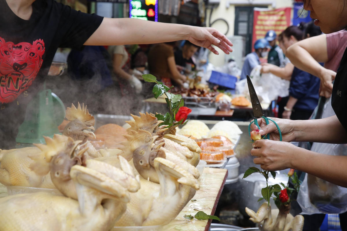  Như mọi năm, những con gà cúng ngậm hoa hồng giá cao ngất ngưởng vẫn được rất nhiều người dân lựa chọn.