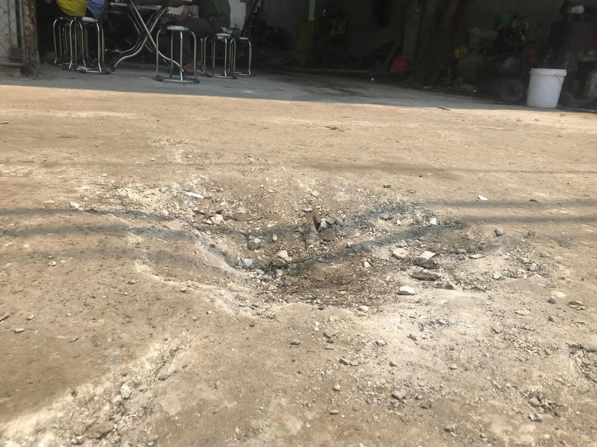 Một cái hố sâu xuất hiện sau vụ nổ, ngay trước sảnh của gara ô tô.