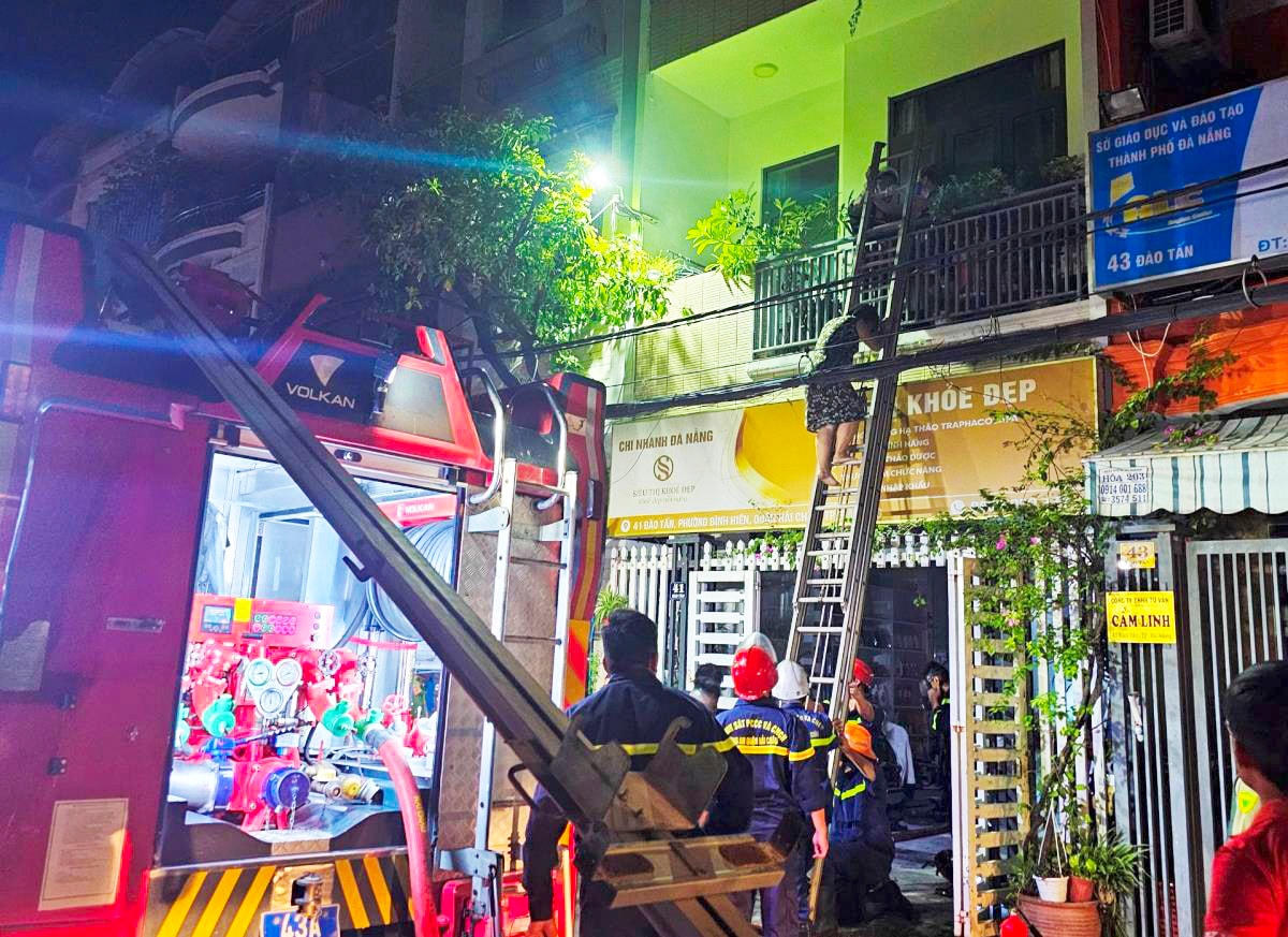 Cảnh sát PCCC&CNCH Công an quận Hải Châu dùng thang đưa 3 người từ tầng 2 ngôi nhà ra ngoài.