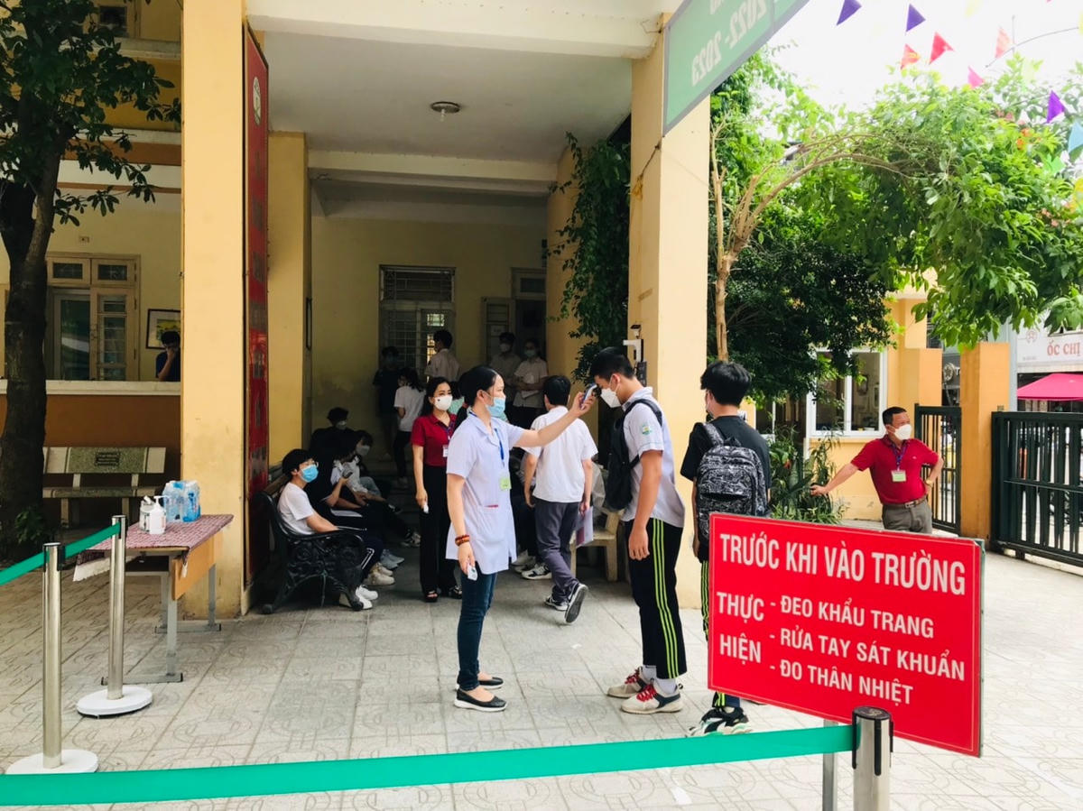Thí sinh được đo thân nhiệt trước khi vào phòng thi tại điểm thi THCS Nguyễn Tri Phương.