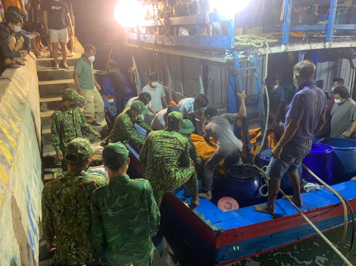 Lực lượng chức năng đưa thi thể ngư dân Nguyễn H. vào bờ.