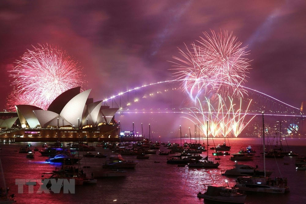 Màn pháo hoa rực rỡ sắc màu đón Năm mới 2023 tại cầu cảng ở thành phố Sydney (Australia). (Ảnh: AFP/TTXVN).