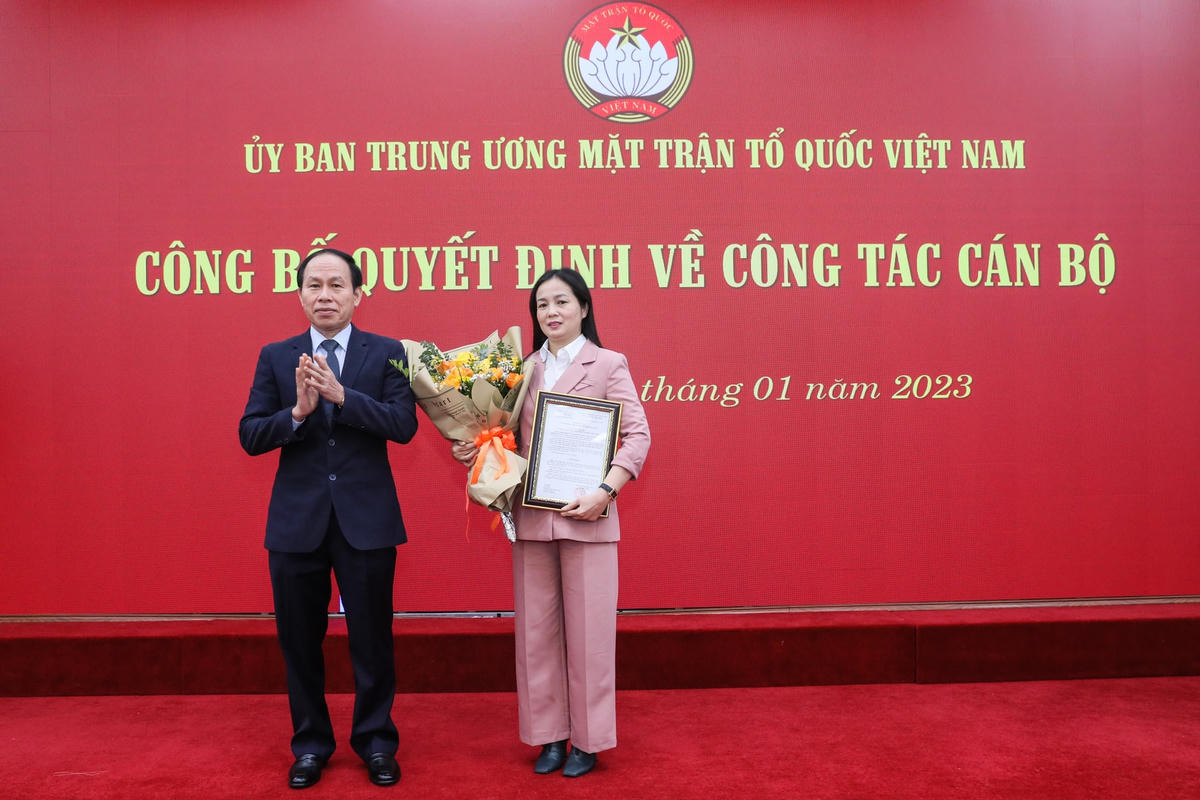 Phó Chủ tịch - Tổng Thư ký Lê Tiến Châu trao quyết định và tặng hoa chúc mừng bà Nông Thị Mai Huyền.