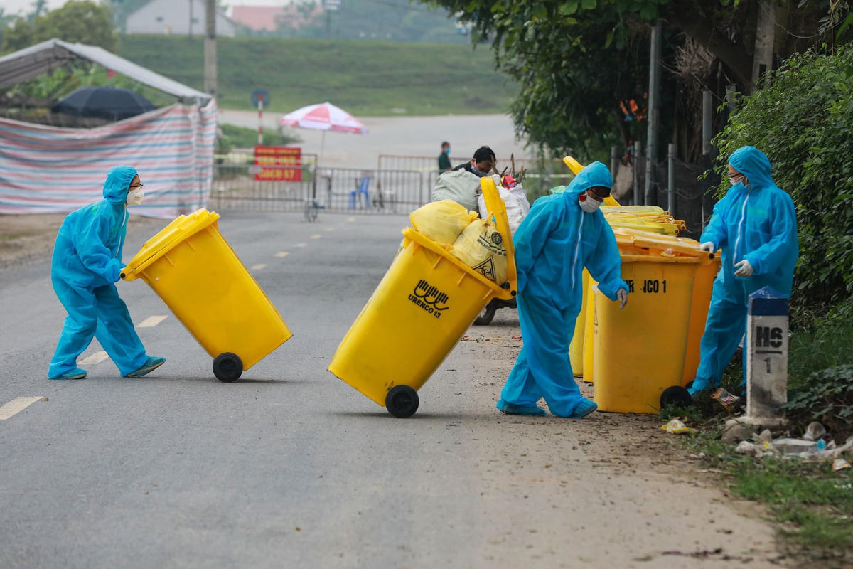 Nhân viên môi trường thu gom rác thải ở Hạ Lôi trong những ngày cách ly.